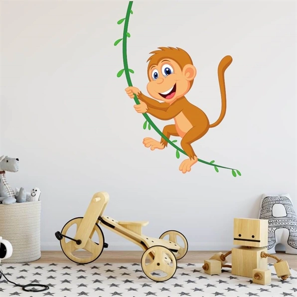 En wallsticker med en ape som svinger i en liane