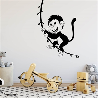 En wallsticker med en ape som svinger i en liane